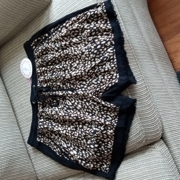 Umgee Other - Umgee medium animal print front, solid black cheeky shorts with fringed hem. NWT